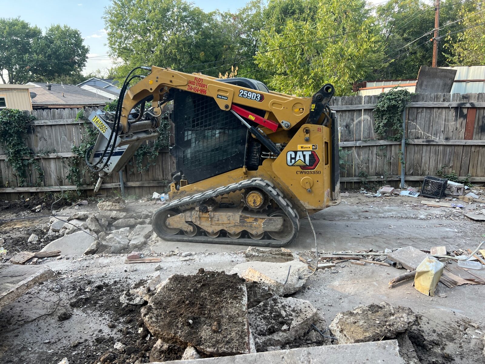 Excavator breaking up concrete