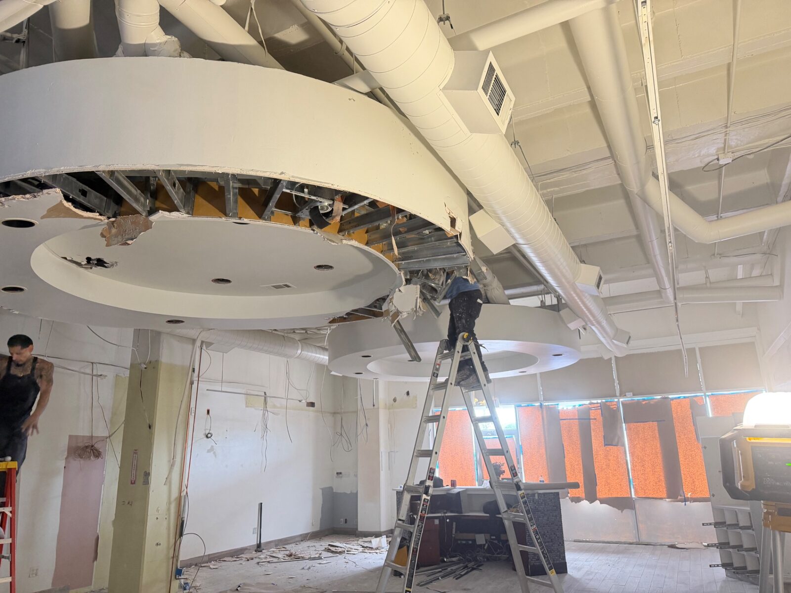 Crew removing ceiling in an office