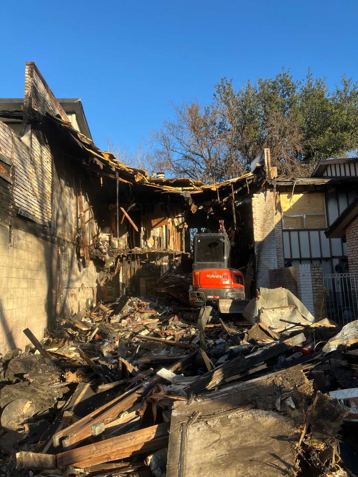 Excavator removing demolition debris